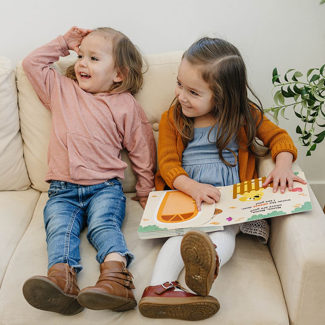 Toddlers reading a lift the flap photo book 